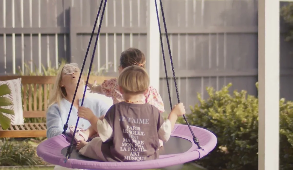 A child on the outdoor nest swing at the practice
