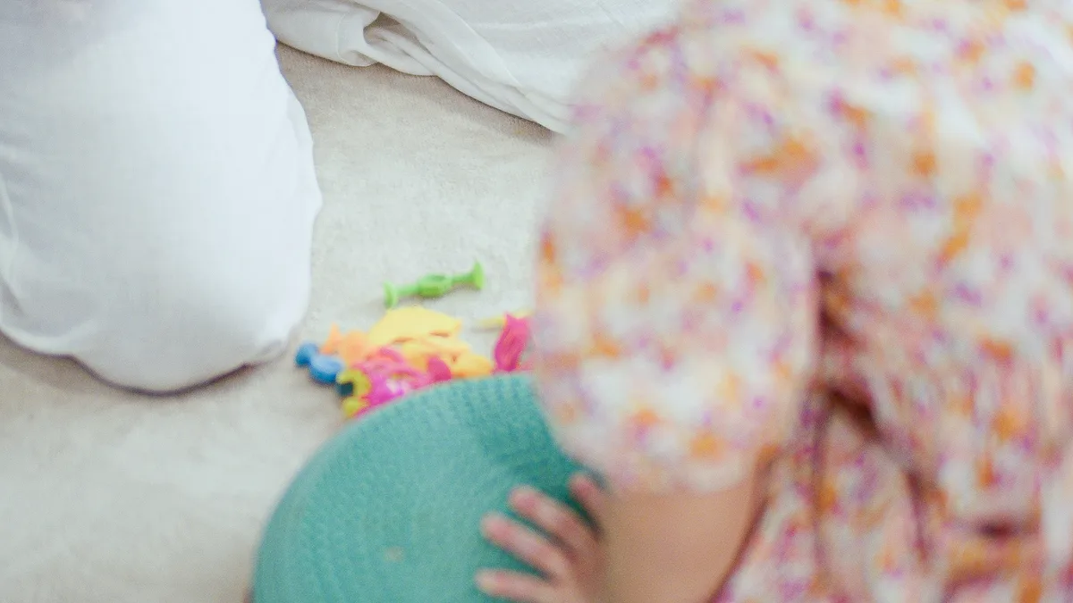 A parent and child playing together on the rug at Wild Springs