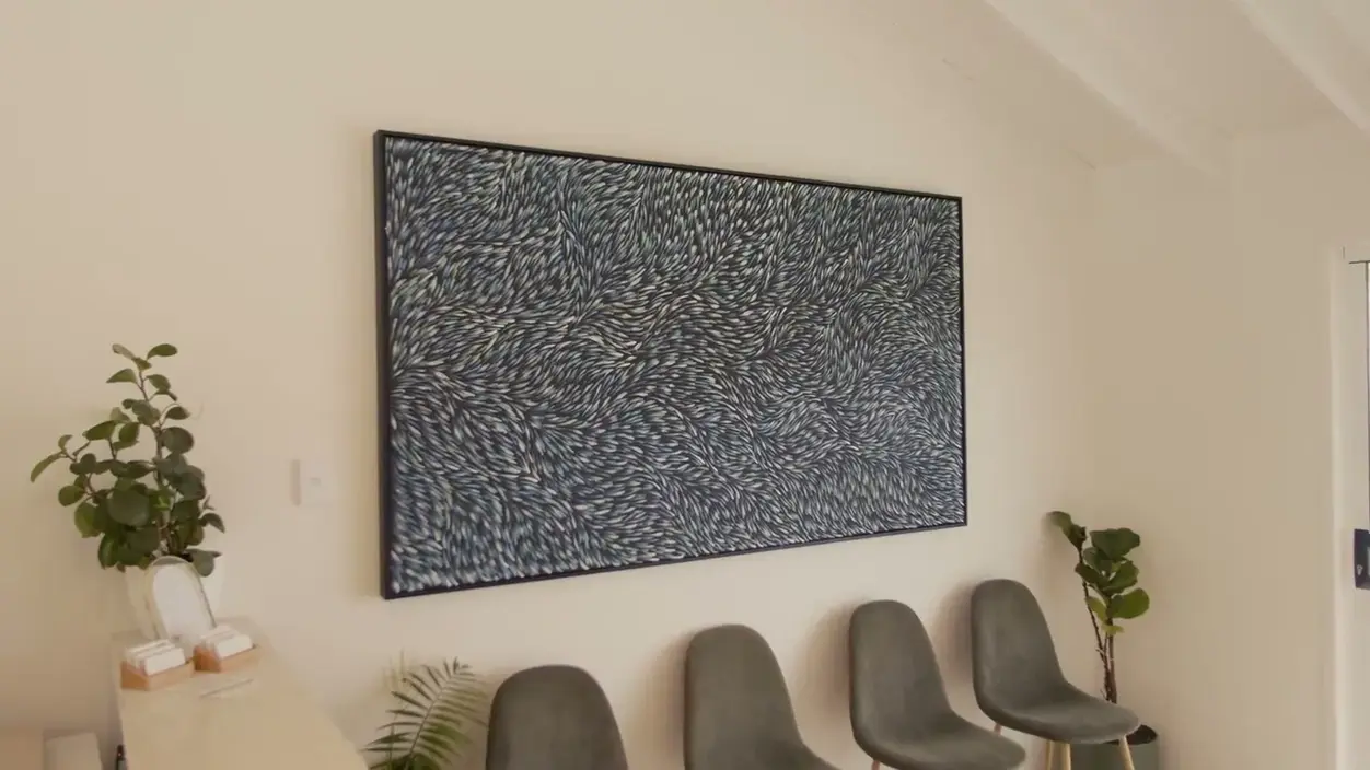 The waiting area with artwork and soft seating