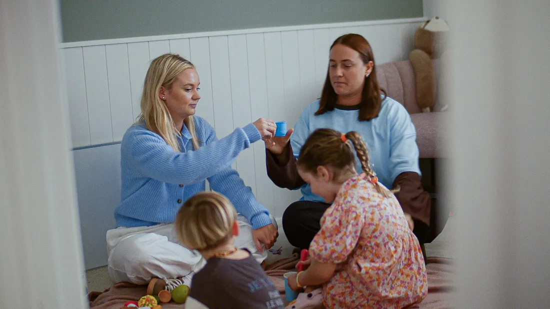 Hayley and Samantha playing on the floor with two children